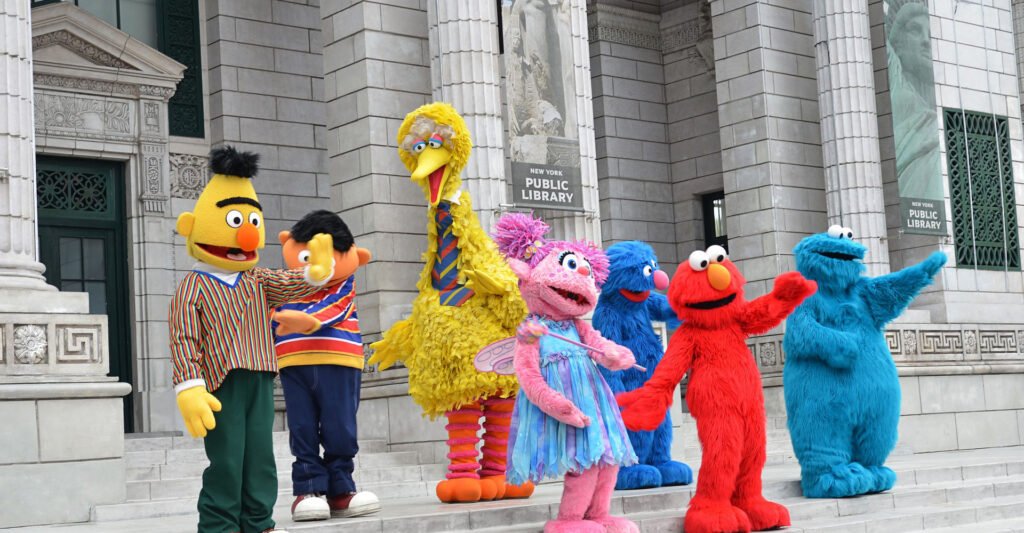 Elmo standing with other character friends